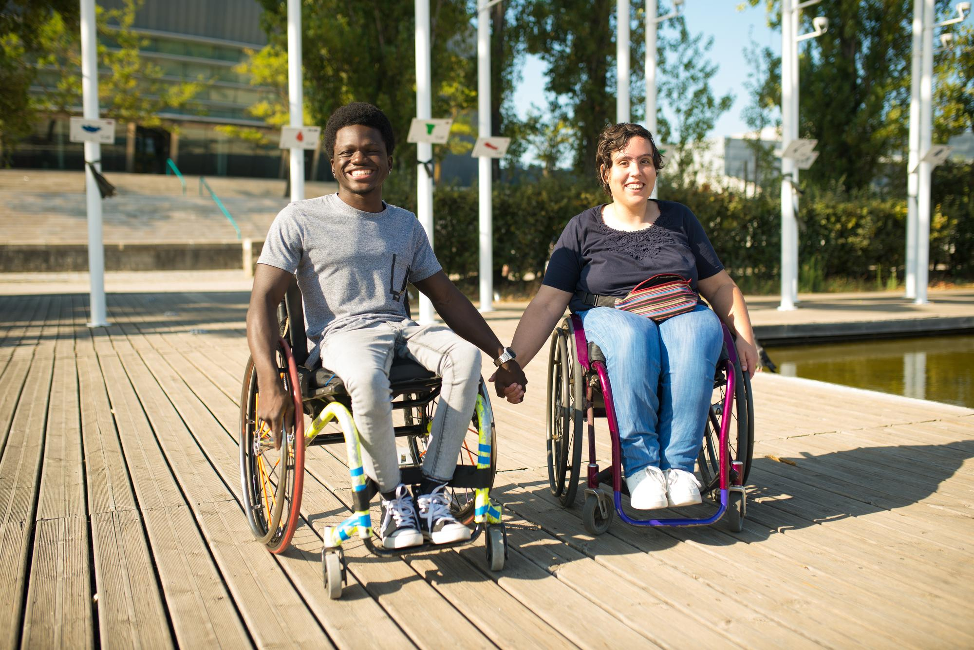 loving-man-woman-wheelchairs-spending-time-near-water-african-american-man-caucasian-woman-casual-clothes-holding-hands-love-affection-happiness-concept